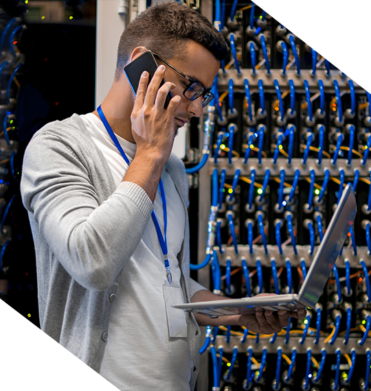 Man in Server Room on a phone
